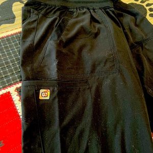 Scrub pants black. One back pocket two front pockets and one pocket on the leg.